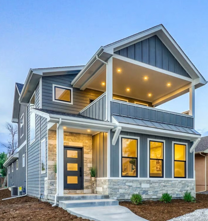 Modern two-story house with balcony and lights