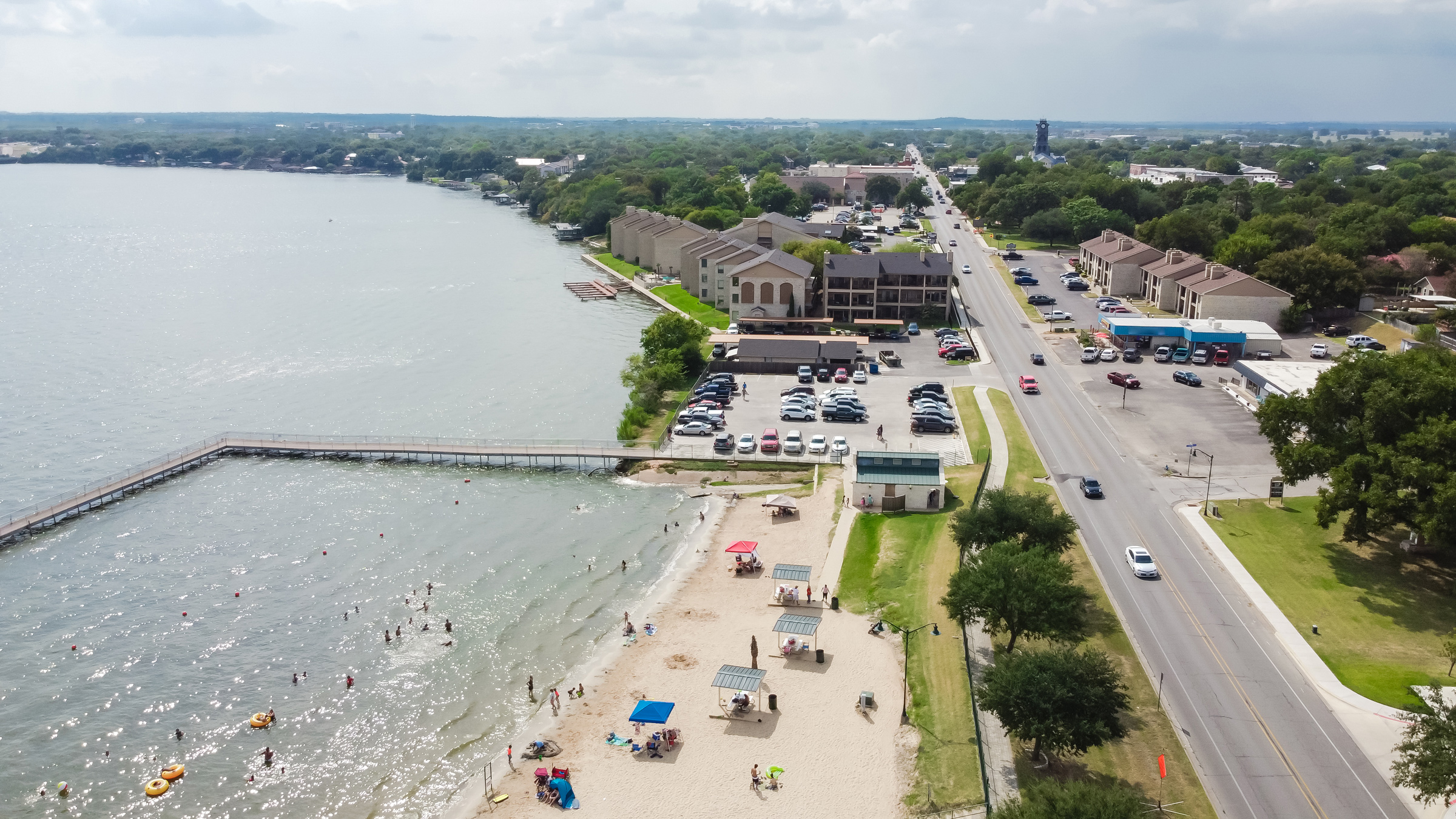 Aerial view of Granbury lakeside beach and city road.