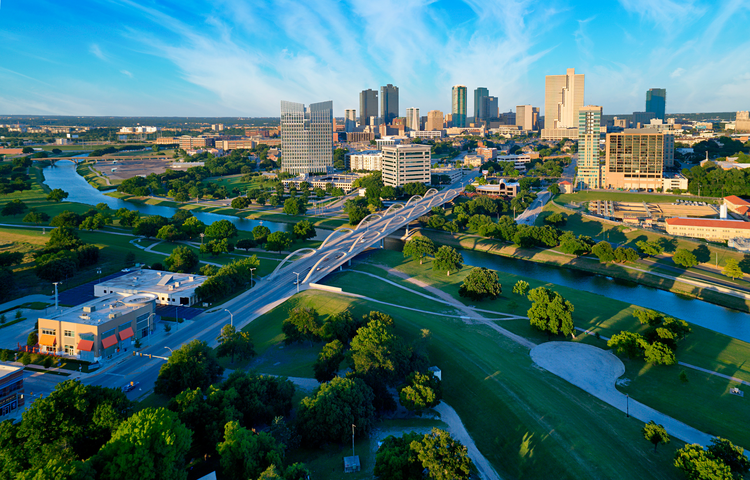Fort Worth skyline with bridge and river view.