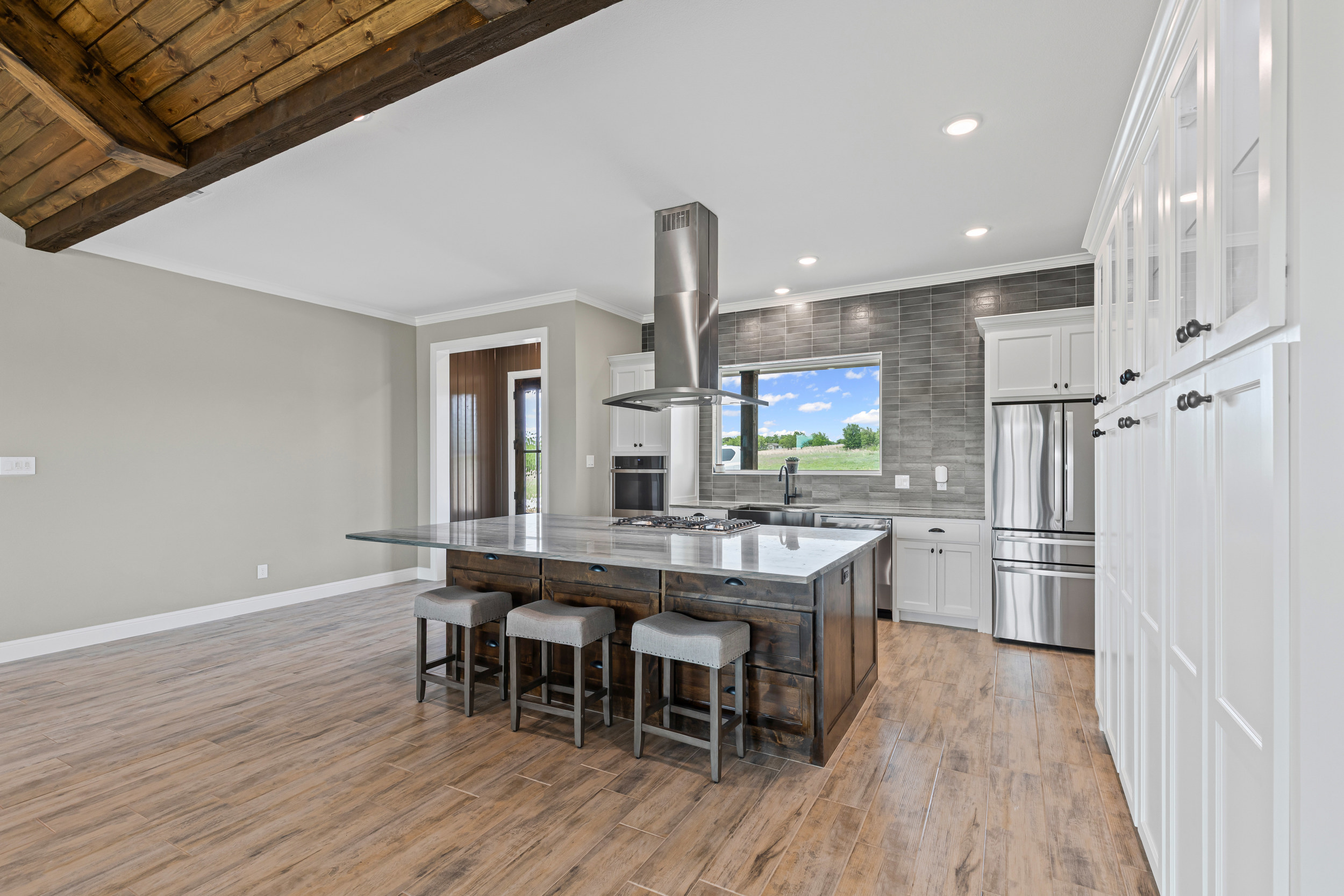 Modern kitchen with island and stainless steel appliances.
