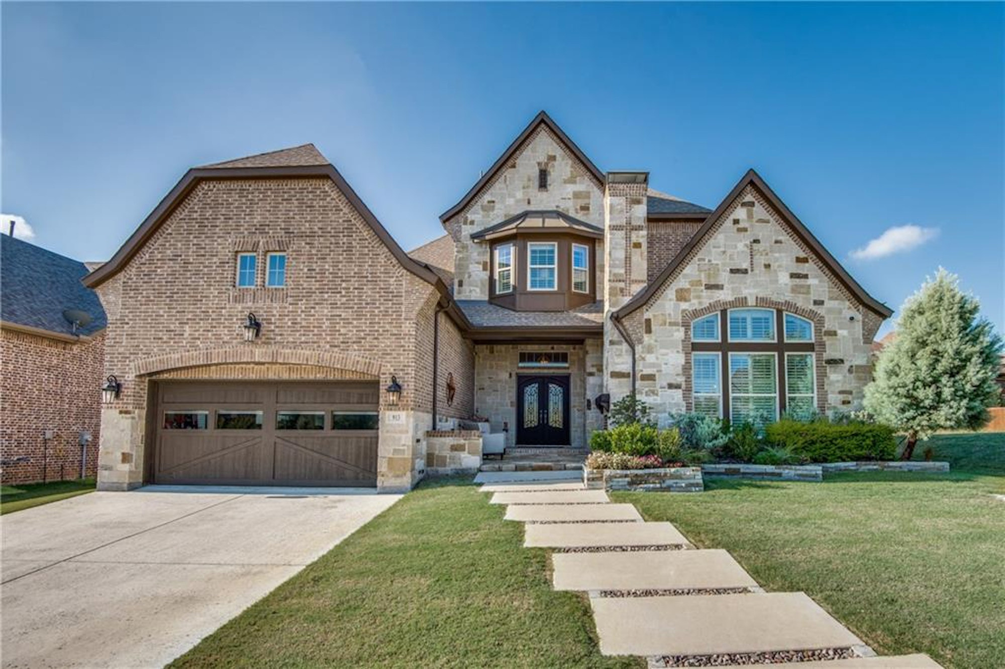 Modern brick house with manicured lawn